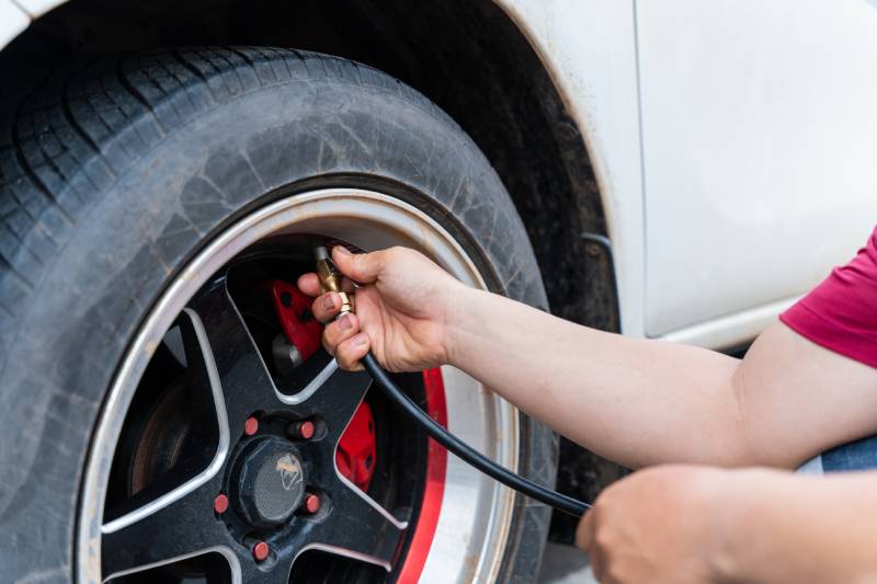 close-up-of-man-filling-air-in-the-tires-of-his-ca-2026-01-07-00-16-10-utc (1)