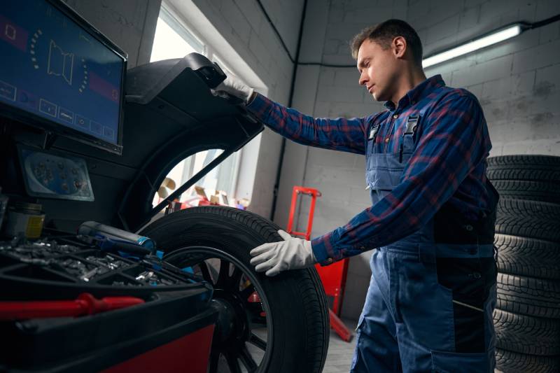 mechanic-controlling-machine-checking-wheel-condi-2026-01-05-06-20-19-utc (1)