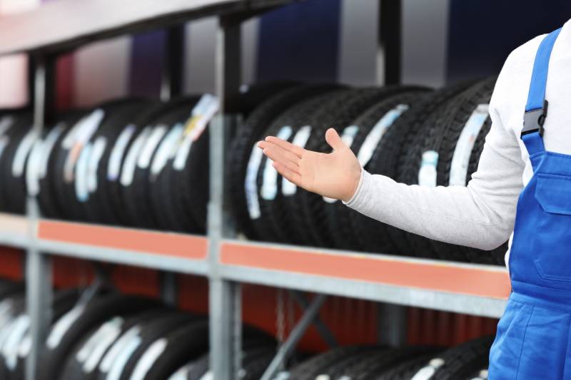 mechanic-near-rack-with-car-tires-at-service-stati-2026-01-05-19-01-38-utc (1)