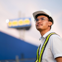 a-man-wearing-a-hard-hat-and-safety-vest-stands-in-2026-03-25-03-09-52-utc (1)